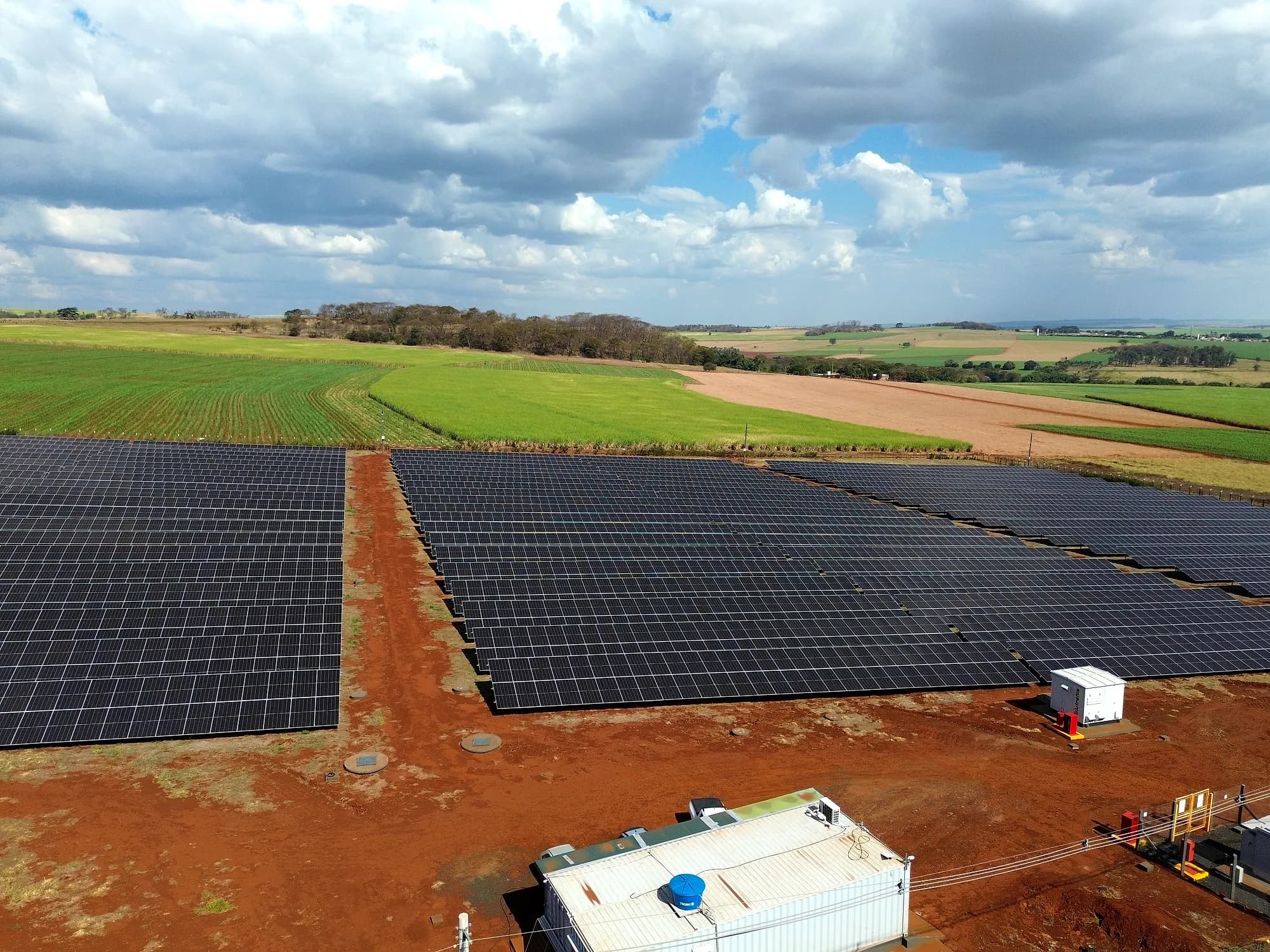 Vista aérea da UFV Igarapava com as fileiras de painéis e a cabine de energia